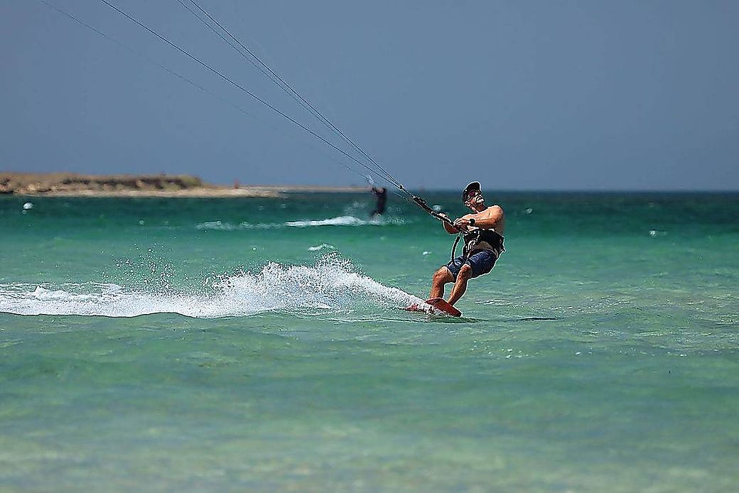 Kitesurfer in action on turquoise water at Paje, Zanzibar