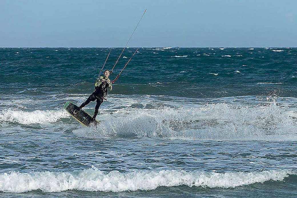 Kite boards and gear lined up on Paje beach, Zanzibar